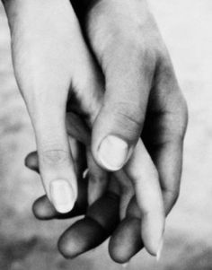 two hands holding each other in front of a black and white photo with the caption,