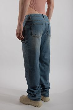 Low-rise and oversized jeans crafted with premium cotton. A relaxed fit that bunches at the bottom. Featuring six pockets: four smock-like pouches at the front and two regular pockets at the back. Style runs large, please size down if between sizes. Machine wash, tumble dry low 70% Cotton, 15% Polyester, 13.8% Viscose Fiber, 1.2% Spandex Knitted Swimsuit, Oversized Jeans, Jean Crafts, Camel Sweaters, Nyc Shopping, Swimwear Dress, Washed Denim, Knitwear Tops, Fashion Line