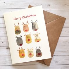 a christmas card with reindeer heads on it