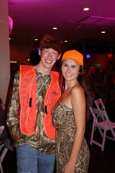 a young man and woman standing next to each other