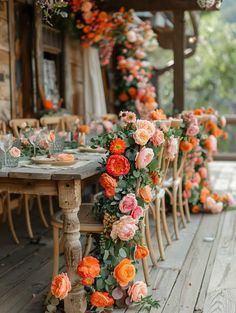 an outdoor dining area decorated with flowers and greenery for a wedding or special event