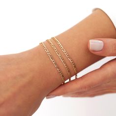 Our new simple and dainty Figaro chain bracelets, as always made in 14k solid gold. You can wear this bracelet with a free mind without worrying about water, perfume, or conditioner contact since real gold never tarnishes.★ Features of the Bracelet (this listing is for a single bracelet only)• Gold Kt: 14K Solid Gold (all pieces are stamped for authenticity)• Available Gold Color: Yellow Gold• Chain Width: 2.5 mm Single Bracelet, Water Perfume, Solid Gold Bracelet, About Water, Free Mind, Solid Gold Chains, Chain Bracelets, Figaro Chains, Figaro Chain