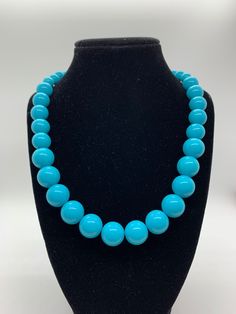 Turquoise colored beaded necklace of varying sized beads. A fun piece to add a pop of color to your work or casual outfit! Necklace is 29 inches with a 3 inch extender Blue Turquoise Necklace With Colorful Beads, Blue Turquoise Necklace With Colorful Round Beads, Turquoise Necklace With Large Beads, Turquoise Necklace With Large Round Beads, Turquoise Beaded Necklaces With Round Beads, Turquoise Necklaces With 8mm Beads, Turquoise Necklaces With 8mm Round Beads, Adjustable Turquoise Necklace With 8mm Beads, Turquoise Necklace With 8mm Round Beads