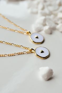 This is a new favorite minimal charm necklace. It's SO pretty. White charm with a gold heart in the middle, and it's hanging from our logan chain. Layer this up with a Luna necklace and you've got a really beautiful stack. Gold-filled is the closest alternative to solid gold. Gold filled jewelry has a thick layer of solid gold bonded onto the base layer, usually brass or sterling silver. Compared to gold plated which uses a process of electroplating that quickly dips your jewelry in gold, result Luna Necklace, Delicate Jewellery, Heart Charm Necklace, Gold Bond, Delicate Jewelry, Dark Wallpaper, Gold Filled Jewelry, Gold Heart, Gold Design