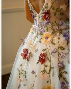 the back of a woman's dress with flowers on it