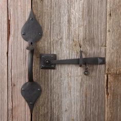 an iron door handle on a wooden door