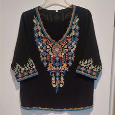 Like New! Never Worn. Unbranded Black Boho Beachy V-Neck Blouse With Floral Embroidery Front And Back! 3/4 Sleeves, Loose Fit, Fully Lined. Material Is Cotton Rayon Blend. Excellent Quality. No Stains, Rips, Or Pulls. Multicolor Embroidered V-neck Top For Vacation, V-neck Blouse With Multicolor Embroidery For Vacation, Bohemian V-neck Embroidered Top For Vacation, Black Embroidered Top For Summer Festival, Vacation V-neck Embroidered Top With Multicolor Embroidery, Black Embroidered Top With Neckline Detail For Summer, Black Embroidered Neckline Top For Summer, Black 3/4 Sleeve Top For Beach, Floral Embroidered V-neck Top For Beach