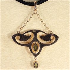 "This gorgeous Art Nouveau pedant has a touch of Egyptian revival flare. With it's floral motifs and bright sparkling spring green Peridot gems, this lovely piece has wonderful lines that make me long for warm days in the garden. This hand crafted pendant was made in England in about 1900. The two peridots add up to about .65 carats. The pendant measures 46.2 mm across and 32.2 mm top to bottom (26.8 mm not including the chain), it weighs 1.6 grams. Thanks! If you like this piece and would like Art Nouveau 14k Gold Jewelry With Gemstones, Art Nouveau Pendant Jewelry With Intricate Design, Art Nouveau Yellow Gold Jewelry With 17 Jewels, Vintage Green Jewelry With Rose Cut Diamonds, Antique May Birthstone Jewelry For Formal Occasions, Art Nouveau Engraved Yellow Gold Jewelry, Collectible Art Nouveau Yellow Gold Jewelry, Engraved Yellow Gold Art Nouveau Jewelry, Art Nouveau Yellow Gold Pendant Jewelry