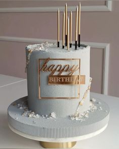 a birthday cake with candles on it sitting on a table