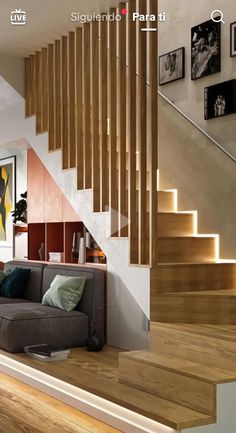 a living room filled with furniture next to a stair case