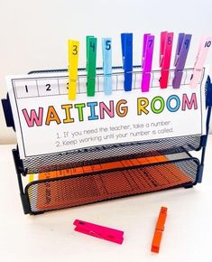 a classroom desk with writing room sign and crayons