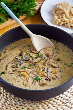 a bowl of mushroom soup with a spoon in it