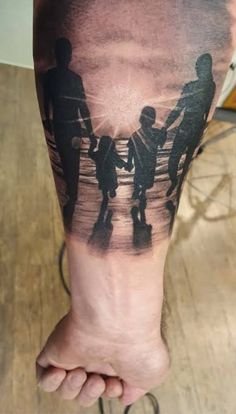 a person with a tattoo on their leg that has two people walking in the water