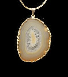 Vintage gold tone and agate slice pendant on 18 inch gold tone chain with spring ring clasp. Natural agate beautifully sliced to expose the crystals of the stone. DETAILS: ☼ Pendant approximately 1 3/4 by 2 1/2 inches. ☼ Chain approximately 18 inches. ☼ Approximately 23.7 grams total weight. ☼ ☼ ☼ ☼ ☼ ☼ ☼ ☼ ☼ ☼ ☼ ☼ ☼ ☼ ☼ ☼ ☼ ☼ ☼ ☼ ☼ PLEASE NOTE: ☼ Different items on SALE everyday! Check back often to take advantage of these bargains! ☼ FREE DOMESTIC SHIPPING on purchases of $35 or more. Combined Gold Agate Jewelry With Adjustable Chain, Gold Round Agate Jewelry, Gold Jewelry With Large Round Stone, Gold Agate Necklace With Large Stone, Gold Agate Gemstone Jewelry, Gold Agate Jewelry With Large Pendant, Gold Necklace With Large Round Pendant, Palm Coast, Agate Slice