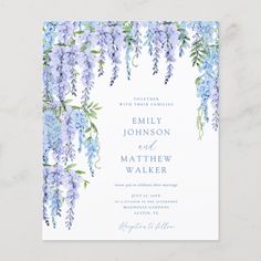 a wedding card with blue flowers and greenery on the front, in watercolor