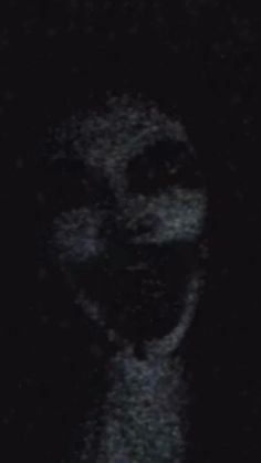 a blurry image of a woman's face in the dark