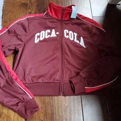 Coca-Cola Crop Zip-Up Sweatshirt Size Extra Small Women New With Tags In Burgundy Red And White 02-10-24 Red Sporty Tops For College, Sporty Red Tops For College, Red Varsity Sports Top, Red Varsity Streetwear Top, Red Varsity Top For Streetwear, Red Varsity Winter Top, Red Varsity Top For Winter, Red Varsity Top With Graphic Print, Retro Red College Tops