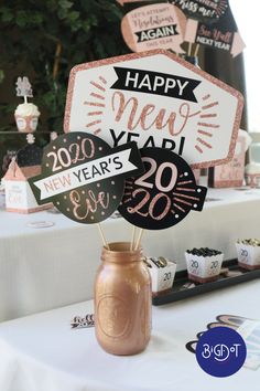 a table that has some decorations on top of it and a sign in the middle