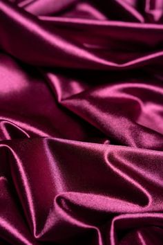 Elevate your creations with our luxurious Magenta Shiny Nylon Fabric! This silky, smooth material features a rich, glossy sheen and a striking magenta hue, perfect for glamorous evening dresses, modern bridal gowns, and high-fashion formalwear. The spandex blend provides 4-way stretch for comfort and unrestricted movement, ensuring your designs are both stylish and functional. This fabric features a lustrous satin finish that adds an elegant touch to any garment! Key Features: - Luxurious Look & Gallagher Aesthetic, Frozen Jr, Modern Bridal Gowns, Glamorous Evening Dresses, Deep Magenta, Mulberry Color, Bridal Attire, Berry Color, Deep Winter