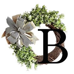 the letter b is decorated with green plants and bows on it's front door