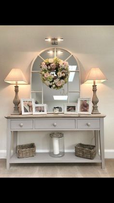 a white table topped with a mirror and two lamps