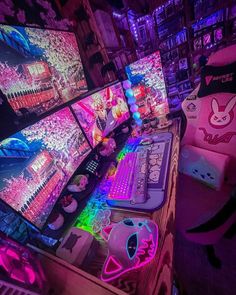 several computer monitors are lit up with neon lights in front of them and on top of each other