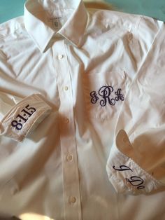 a white shirt with two initials on it