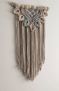 a wall hanging with some tassels on it