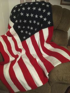 an american flag blanket draped over a recliner