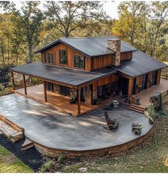 an aerial view of a large house in the woods