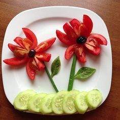 a white plate topped with cucumber slices and flowers