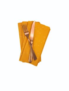 three napkins with gold colored forks on them