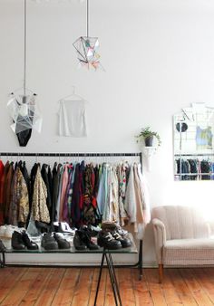 a clothing rack with shoes and clothes hanging on it