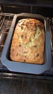 a loaf of bread sitting in an oven on top of a metal pan with some sort of crust