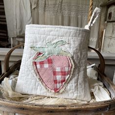 a basket with a patchwork strawberry on it