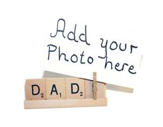 a scrabbled wooden block with the word dad written on it and a sign that says, add your photo here