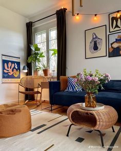 a living room filled with furniture and pictures on the wall