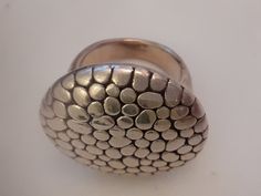 Up for sale is a Large Round Modern Textured Statement ring in .925 Sterling Silver. Very fun ring! Ring Size: 29 x 27mm across top Ring Weight: 5.7 - 6 grams Rabbask Designs is a small business located in Loveland, Colorado. We have art works for sale from over 100 local artists and have an eclectic mix of vintage and handmade jewelry, fine art, shoes, essential oils, women's clothing and more! When you shop at Rabbask you are supporting small, local business, artists and musicians. Thanks for Vintage Silver Hammered Rings, Silver Hammered Oval Ring, Oval Silver Hammered Ring, Handmade Silver Dome Ring, Silver Engraved Hammered Ring, Nickel-free Oval Metal Rings, Shoes Essential, Loveland Colorado, Art Shoes