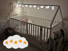 there is a baby crib with stars on the bottom and two stuffed animals in it