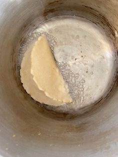 a metal bowl filled with something yellow and brown