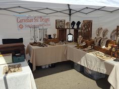 there are many items on the table at this outdoor market stall that is set up for sale