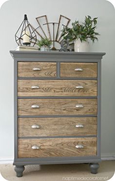 a dresser with drawers and plants on top