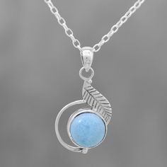 Caressed by a handcrafted sterling silver leaf, a round cabochon of sky blue larimar is featured in the pendant of this necklace. Shanker presents this Indian necklace, which is crafted by local artisans. Silver Amazonite Round Jewelry, Light Blue Sterling Silver Round Necklace, Light Blue Round Sterling Silver Necklace, Spiritual Round Larimar Jewelry, Handmade Light Blue Sterling Silver Necklaces, Handmade Light Blue Sterling Silver Necklace, Handmade Larimar Round Necklace, Handmade Round Larimar Necklaces, Light Blue Sterling Silver Necklace, Nickel Free