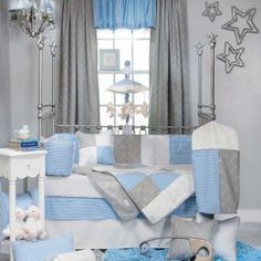 a baby's room is decorated in blue and gray colors with stars on the ceiling