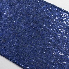 a blue tie with silver sequins on it