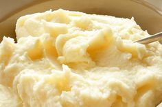 mashed potatoes in a bowl with a spoon