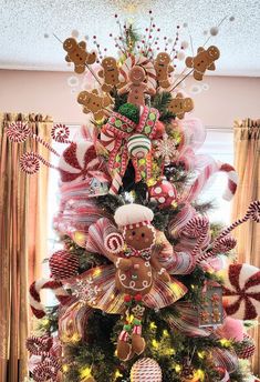 a christmas tree decorated with gingerbreads, candy canes and pretzels