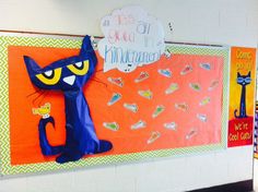 a bulletin board with an image of a blue cat and a yellow bird on it