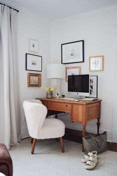 a white chair sitting in front of a wooden desk