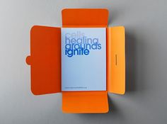 an orange and white brochure on the wall